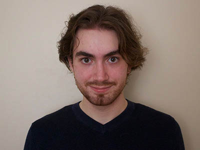 IMAGE #32 – passport type headshot – student with beard and black tee shirt copy
